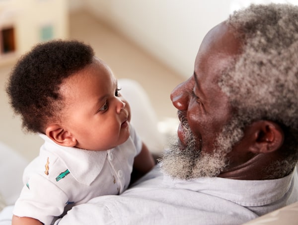 Grandfather smiling at his young grandson
